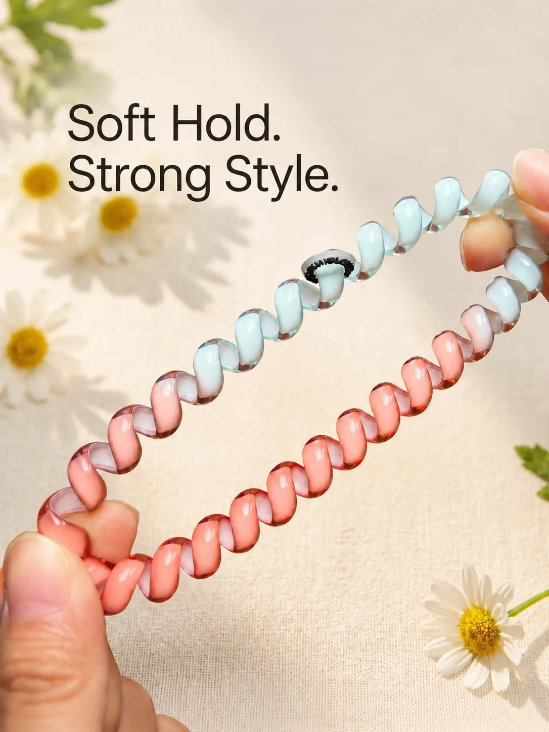 Flexible pink and blue TPU Jelly Spiral Hair Tie stretched by hand to show its soft, resilient coil design.