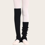 Black over-the-knee stirrup leg warmers made of soft ribbed fabric, great for dance, pilates, and yoga.