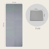 A grey foldable yoga mat measuring 183cm x 61cm, designed by Sportive Lives for easy storage and portability, shown both fully extended and folded into a compact size.