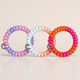 Set of 3 glossy Jelly Spiral Hair Ties in pink, purple, blue and orange colour combinations by Sportive Lives.