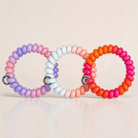 Set of 3 glossy Jelly Spiral Hair Ties in pink, purple, blue and orange colour combinations by Sportive Lives.