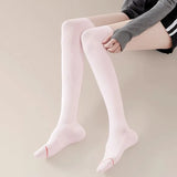 Woman wearing pink over-the-knee compression socks, showcasing slim fit and ergonomic foot support design