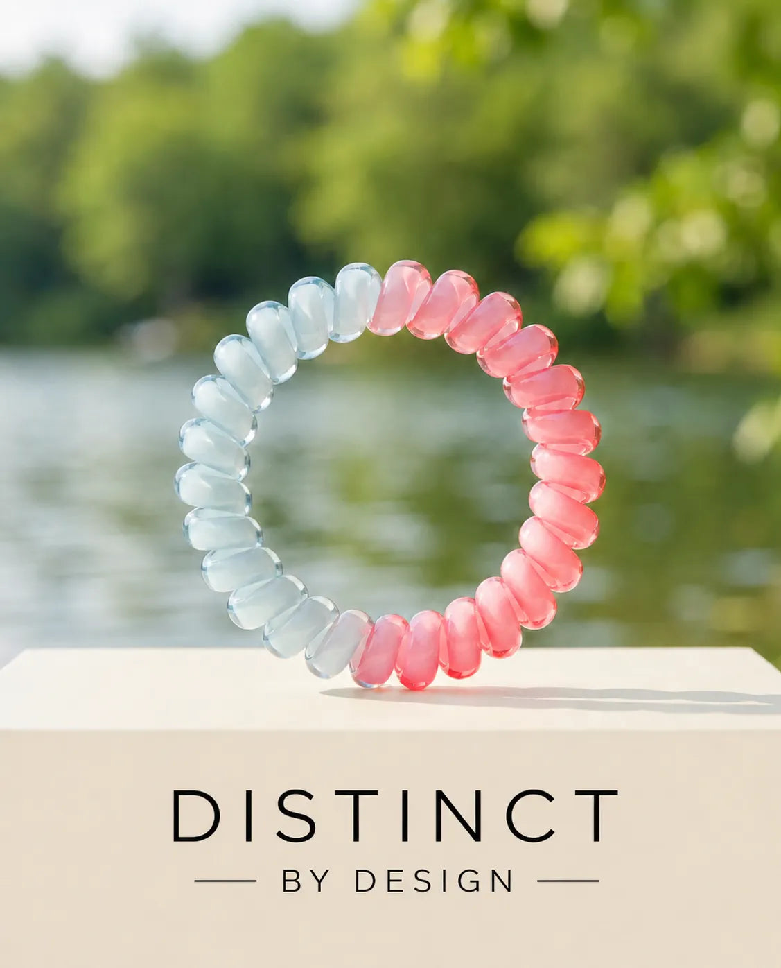 Pink and ice blue two-tone Jelly Spiral Hair Tie with a smooth glossy coil design.