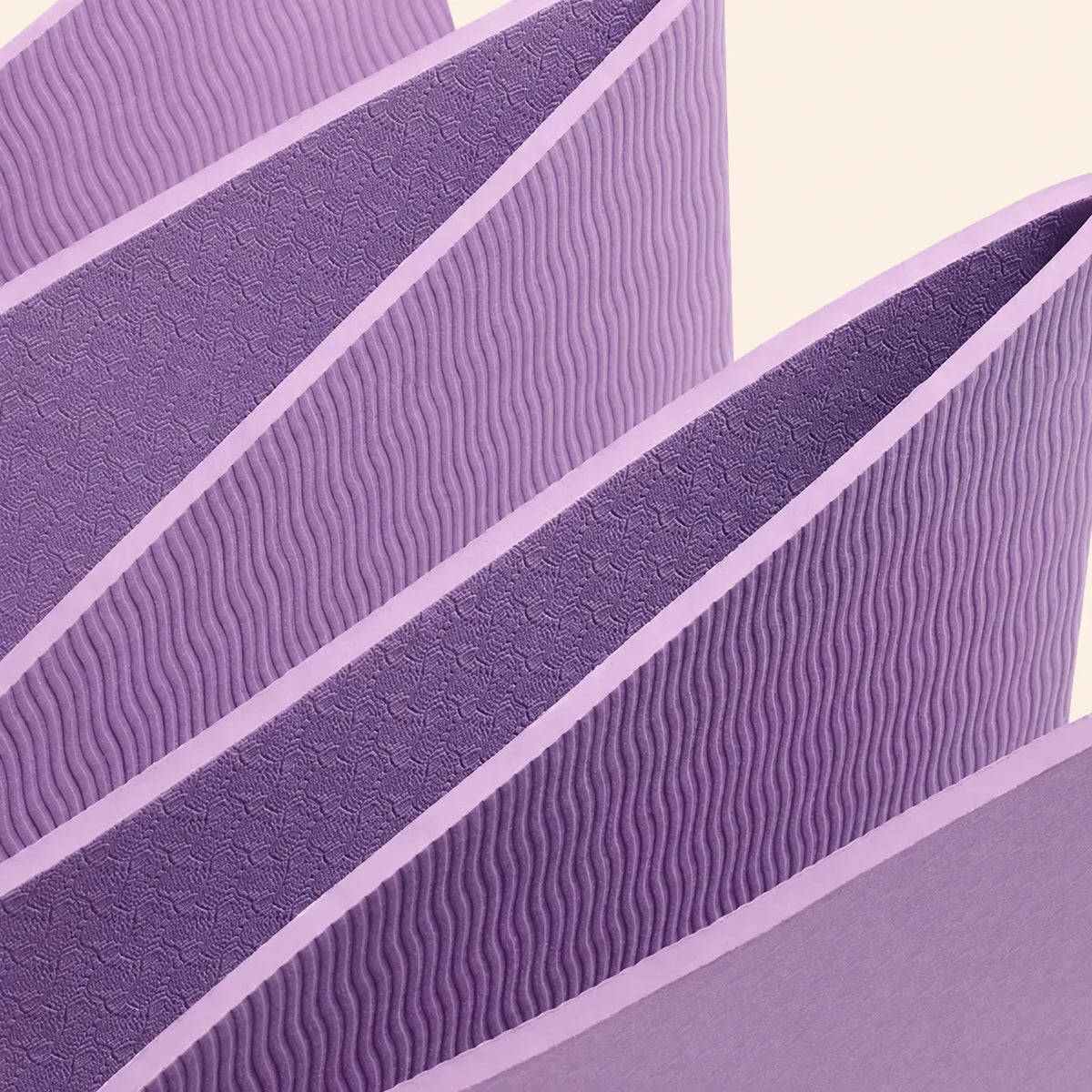 Purple foldable yoga mat showing built-in fold lines and textured TPE surfaces