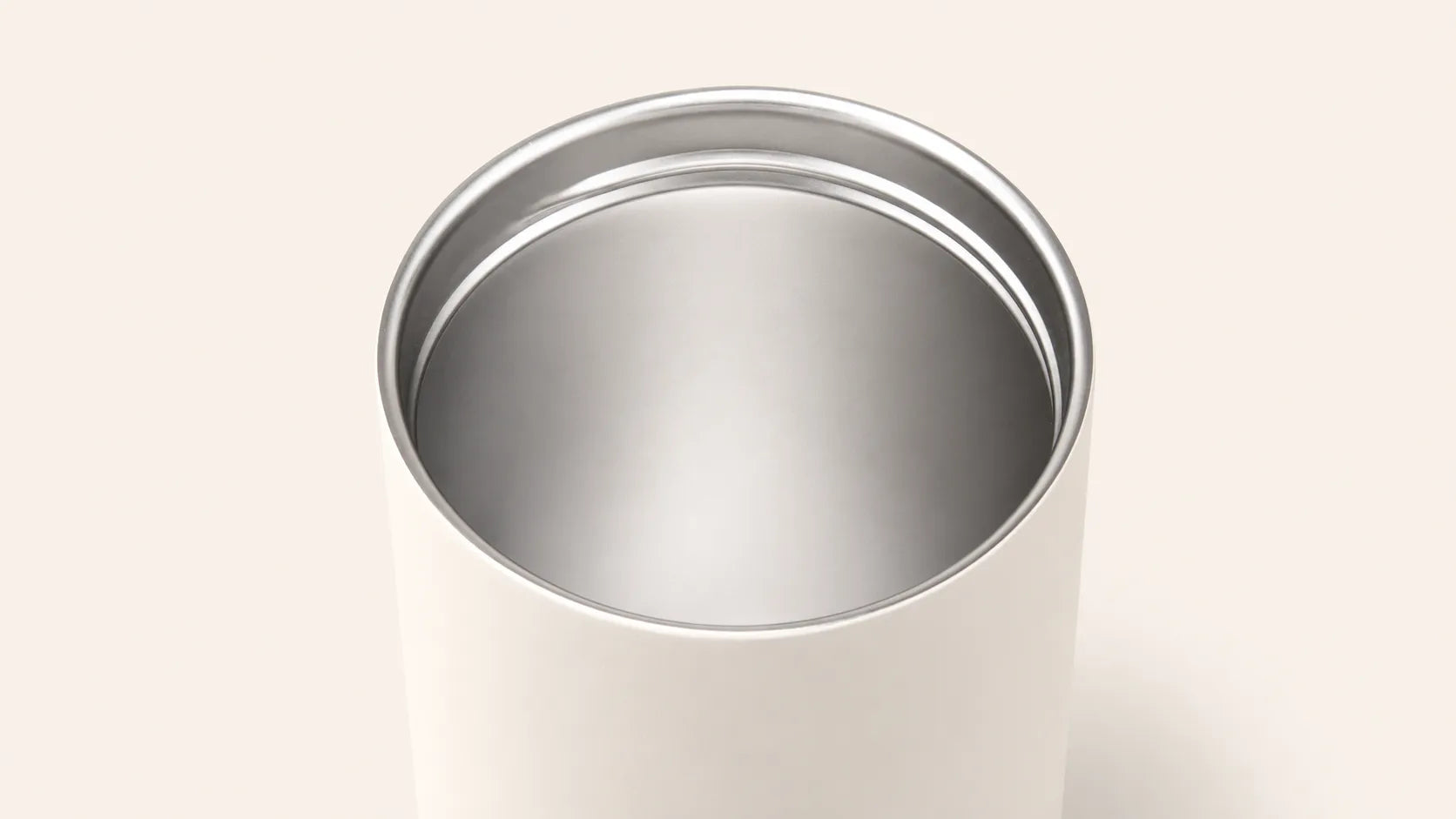 Close-up of the SPL Stainless Steel Straw Bottle showing the smooth stainless steel interior and warm white exterior