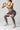 Woman performing squats with a pink Sportive Lives fabric resistance band above knees for glute activation