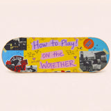 Sportive Lives wooden balance board featuring a colourful yellow collage and graffiti-style decorative sticker design.
