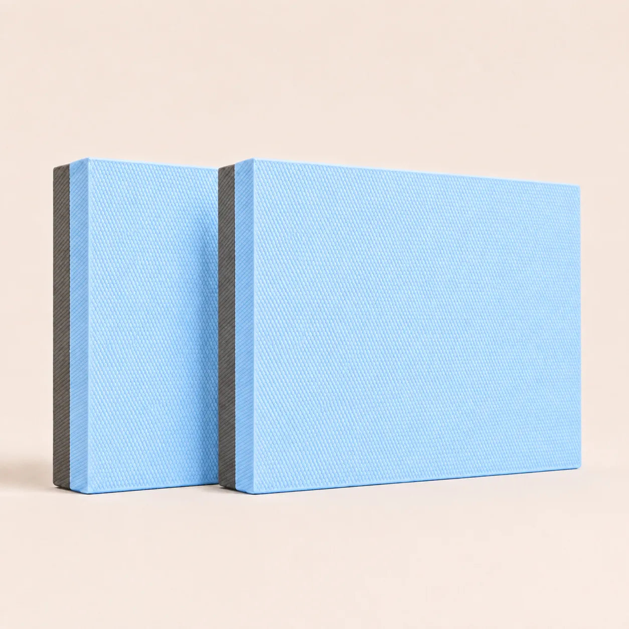 Light blue Sportive Lives TPE yoga balance pad with charcoal bottom layer and textured foam surface for stretching, balance exercises and fitness training.