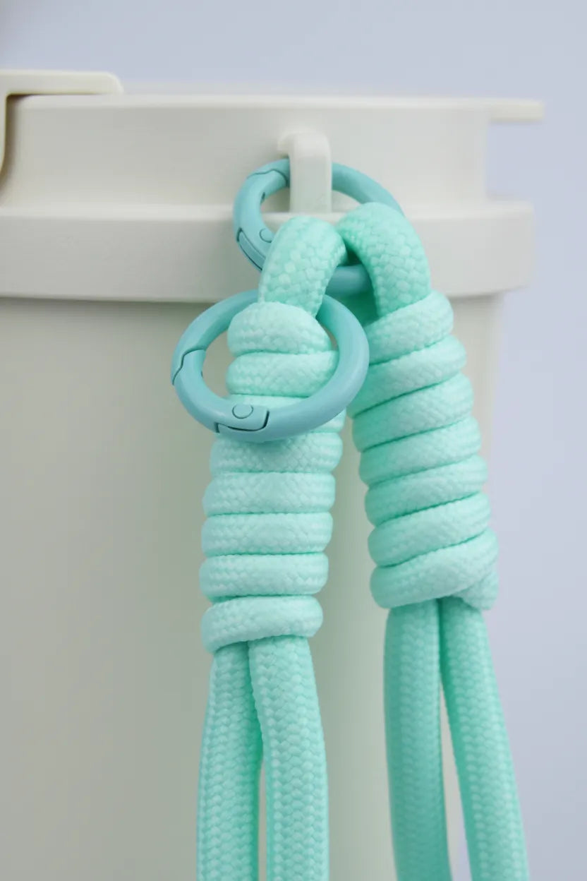 Close-up of Aqua braided rope charm by Sportive Lives—double rings on travel mug hook; durable paracord keychain/tumbler accessory (Canada).