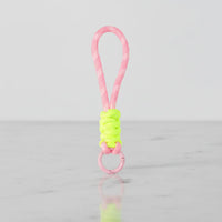 Pastel pink patterned rope with neon-yellow wrap, pink ring—bright clip-on cup handle and bag charm; lightweight braided rope, Sportive Lives Canada.