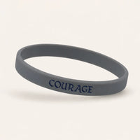 Charcoal grey silicone wristband with navy COURAGE lettering