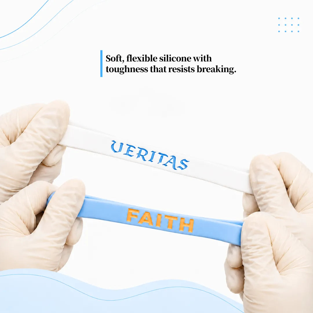 White VERITAS and blue FAITH silicone wristbands stretched to demonstrate flexibility and durability