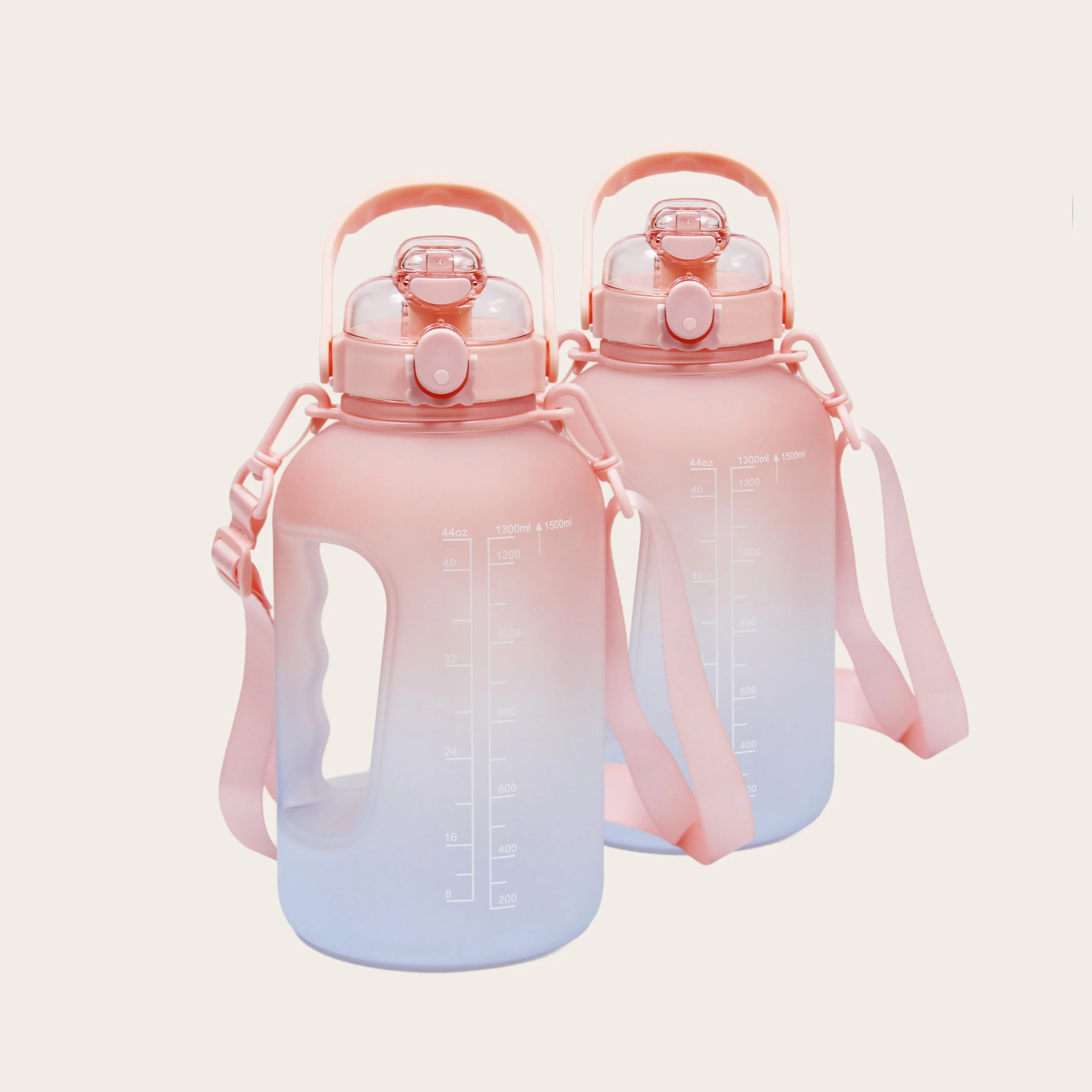 Two Sportive Lives 1.5L gym water bottles in salmon and white gradient with handle and straw, ideal for fitness hydration in Canada