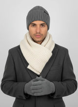 Man in charcoal grey high rib-knit cuffed beanie by Sportive Lives with ivory scarf and gloves; warm unisex knit cap, one size 56–58 cm.