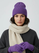 Woman wearing grape purple high rib-knit cuffed beanie (toque) by Sportive Lives with neutral scarf; cozy acrylic blend cold-weather hat.
