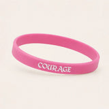 Hot pink motivational silicone wristband with white COURAGE lettering
