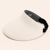 Ivory Sportive Lives reversible sun visor with black inner side, curved brim, and adjustable strap