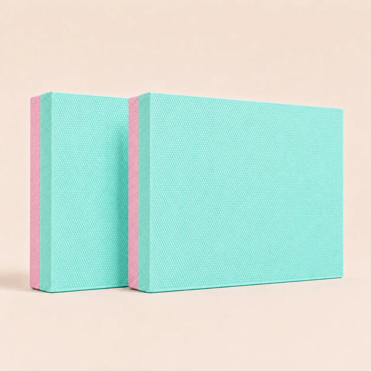 Mint green and pink Sportive Lives TPE yoga balance pad with textured high-density foam for yoga, stretching, balance training and home workouts.
