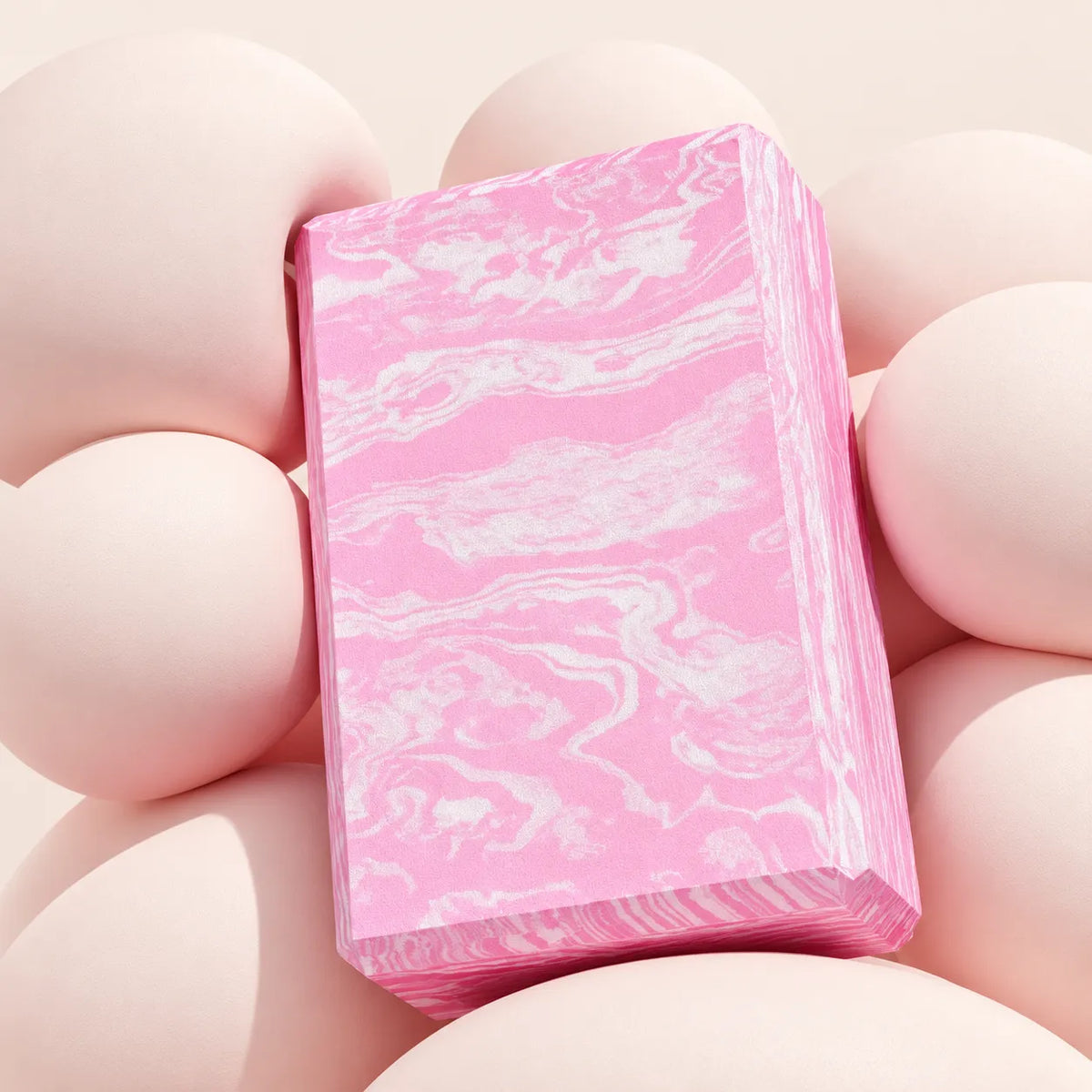 Close-up of the beveled edges and rounded corners on a pink marbled EVA yoga block.