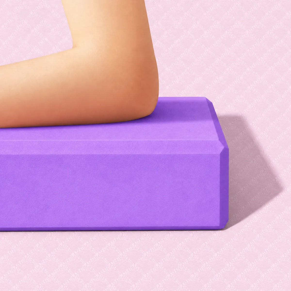 Elbow pressing into a violet EVA yoga block to demonstrate firm support