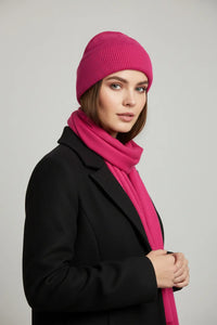 Woman wearing fuchsia pink ribbed cuffed beanie (toque) by Sportive Lives, cozy winter knit hat, Canada.