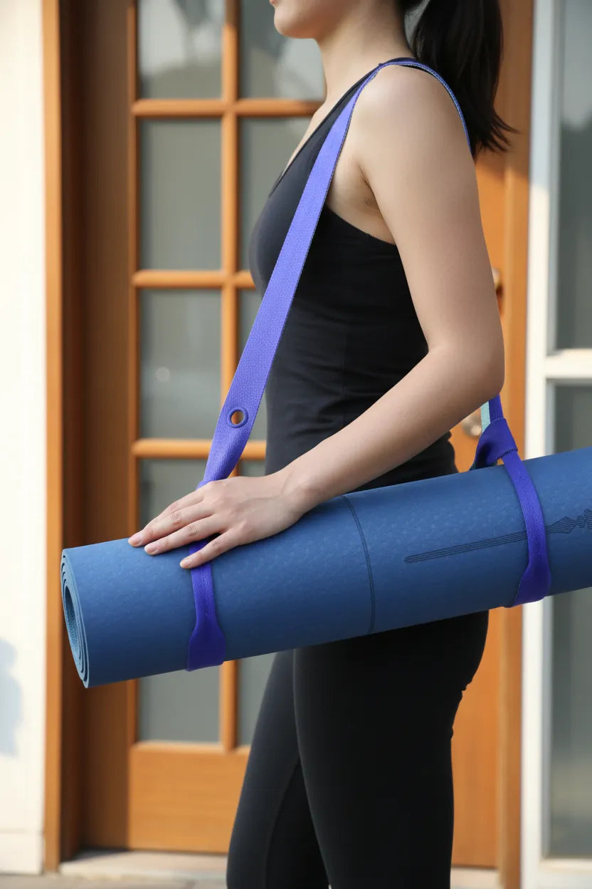 Woman carrying a blue yoga mat with the Sportive Lives Sapphire Blue adjustable strap on her shoulder; comfortable mat sling for women in Canada.