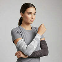 Model in mixed camo cooling UV arm sleeves—grey camo with charcoal camo—lightweight, breathable sun sleeves that stay put — Sportive Lives Canada