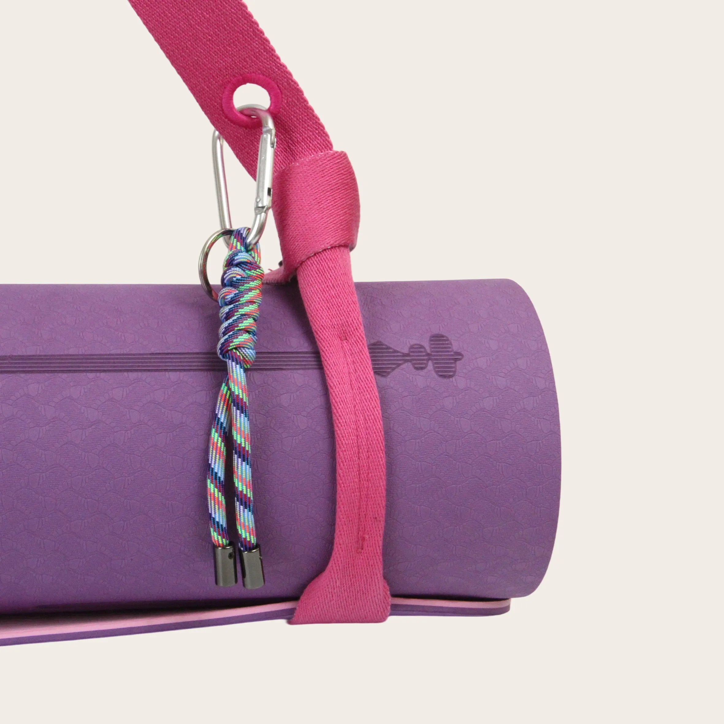 Close-up of Sportive Lives yoga mat strap securing a purple mat with carabiner; secure, adjustable yoga mat sling for Canada.