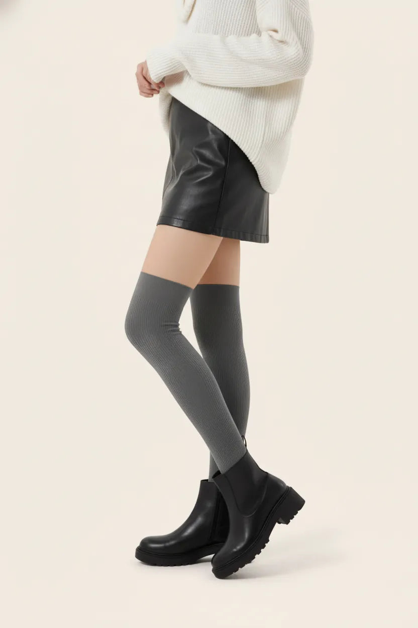 Graphite grey over-the-knee ribbed socks styled with black leather mini skirt and boots.