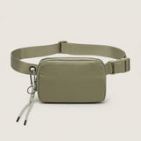 Front view of an olive water-resistant nylon belt bag with adjustable strap, dual zippers and a detachable carabiner key clip.
