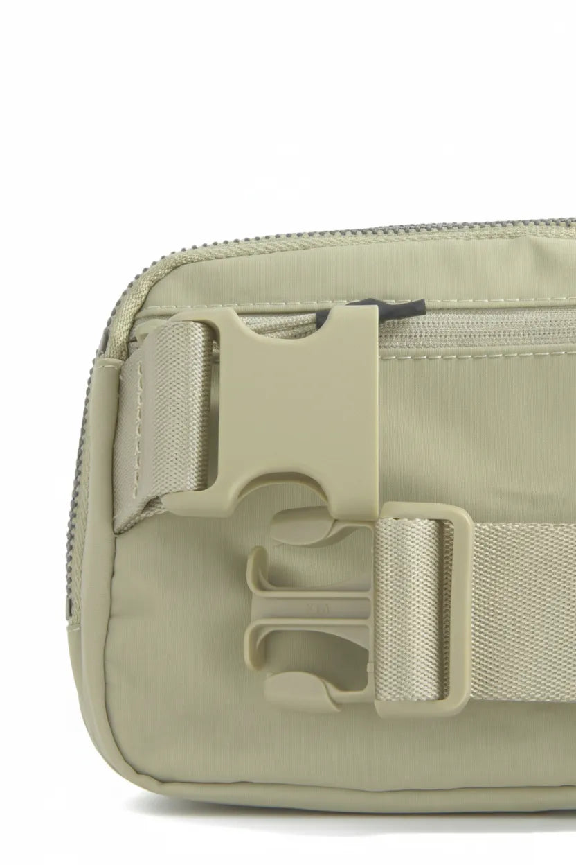Back zip pocket and quick-release buckle on the sage waterproof nylon belt bag for secure, easy everyday carry.