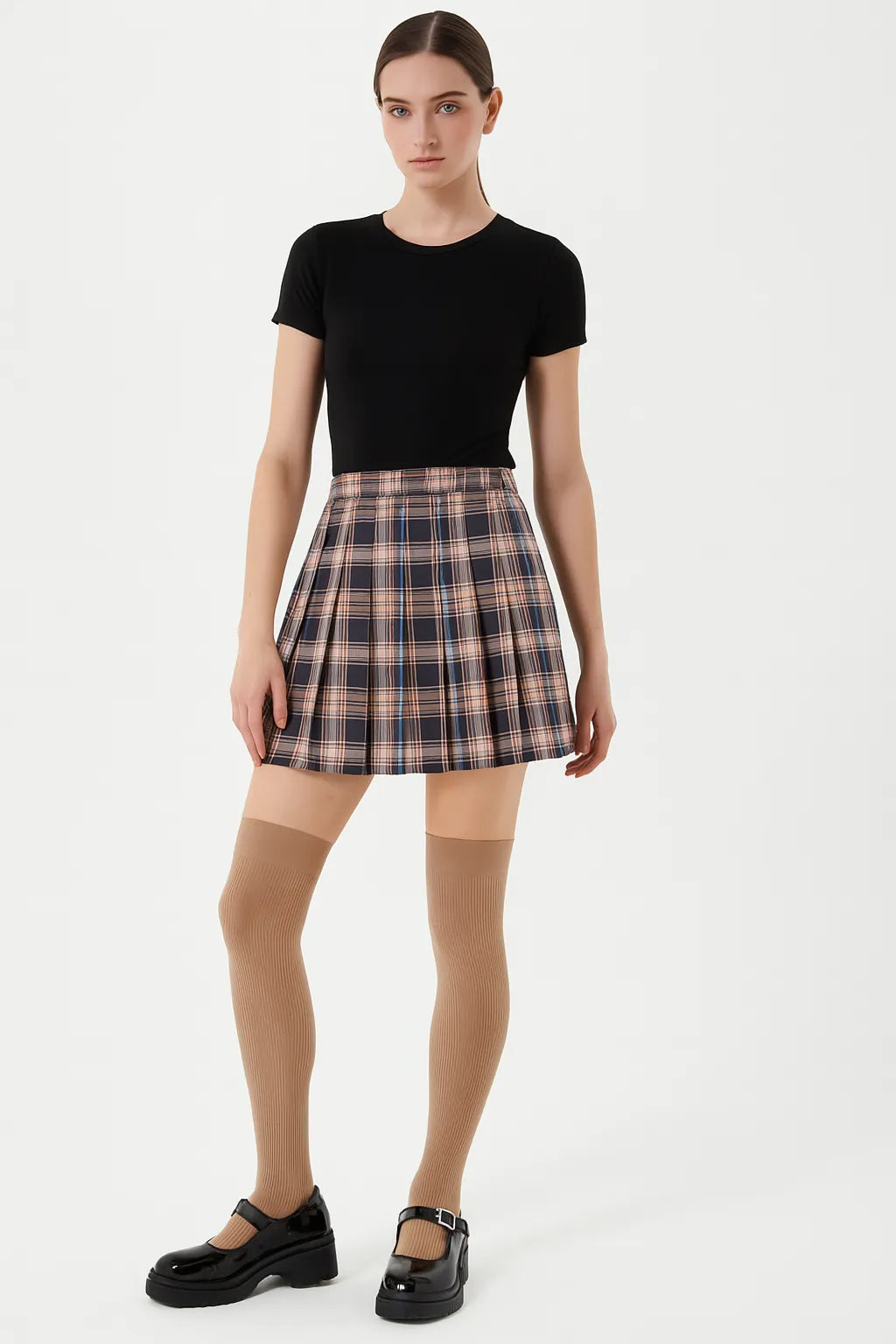 Beige over-the-knee socks styled with plaid skirt and black tee