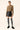 Model wearing dark grey ribbed over-the-knee socks with black leather skirt