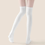 Back view of woman wearing white over-the-knee compression socks with slim fit and breathable texture
