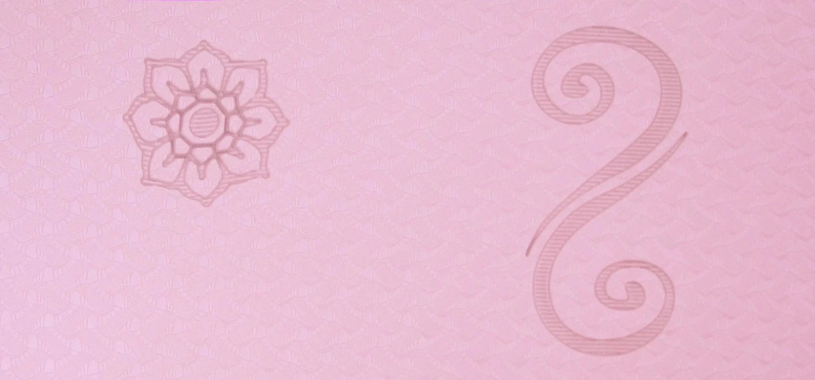 Close-up of pink lotus yoga mat texture showing detailed floral and swirl patterns for improved grip and alignment. Eco-friendly material, designed for ultimate comfort during yoga practice. Available in Canada through Sportive Lives.